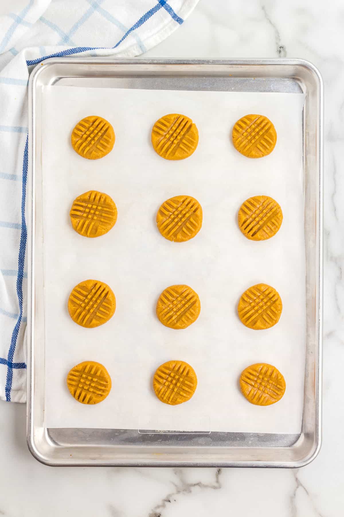 Criss crossed peanut butter cookies on sheet pan