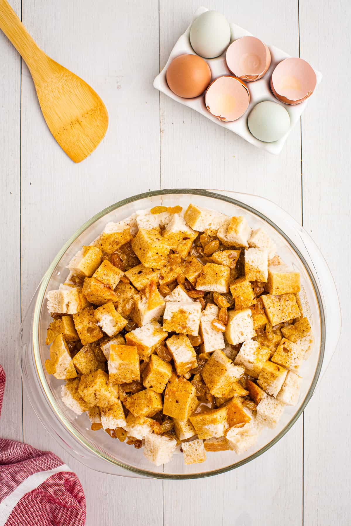 Pieces of bread with egg custard poured over it in a bowl