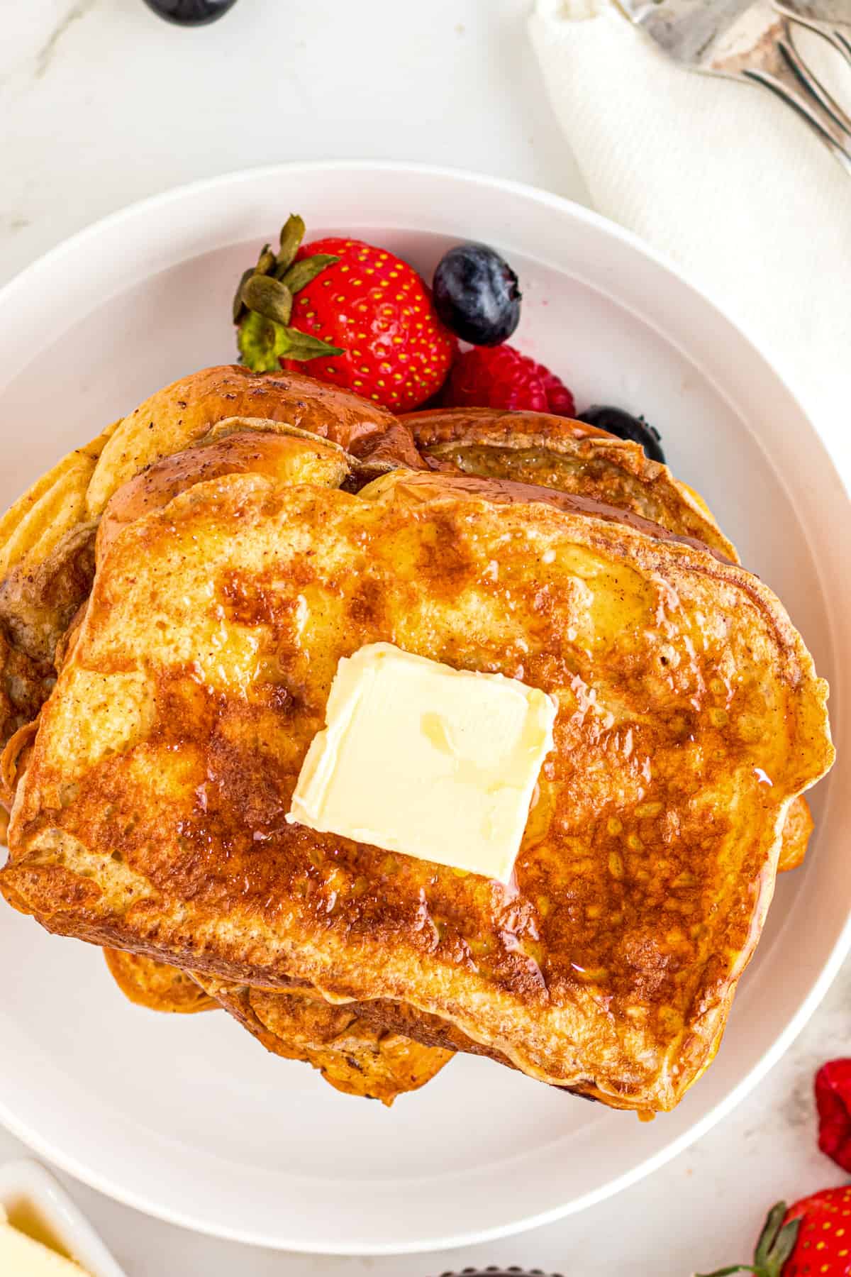 Overhead image of white plate with Brioche French Toast