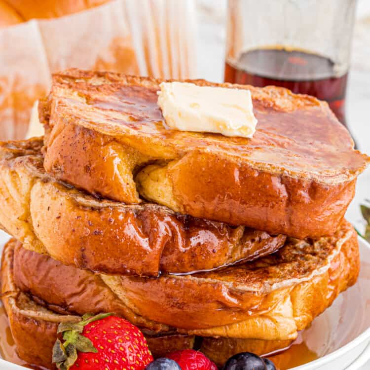 Stack of Brioche French Toast on white plate