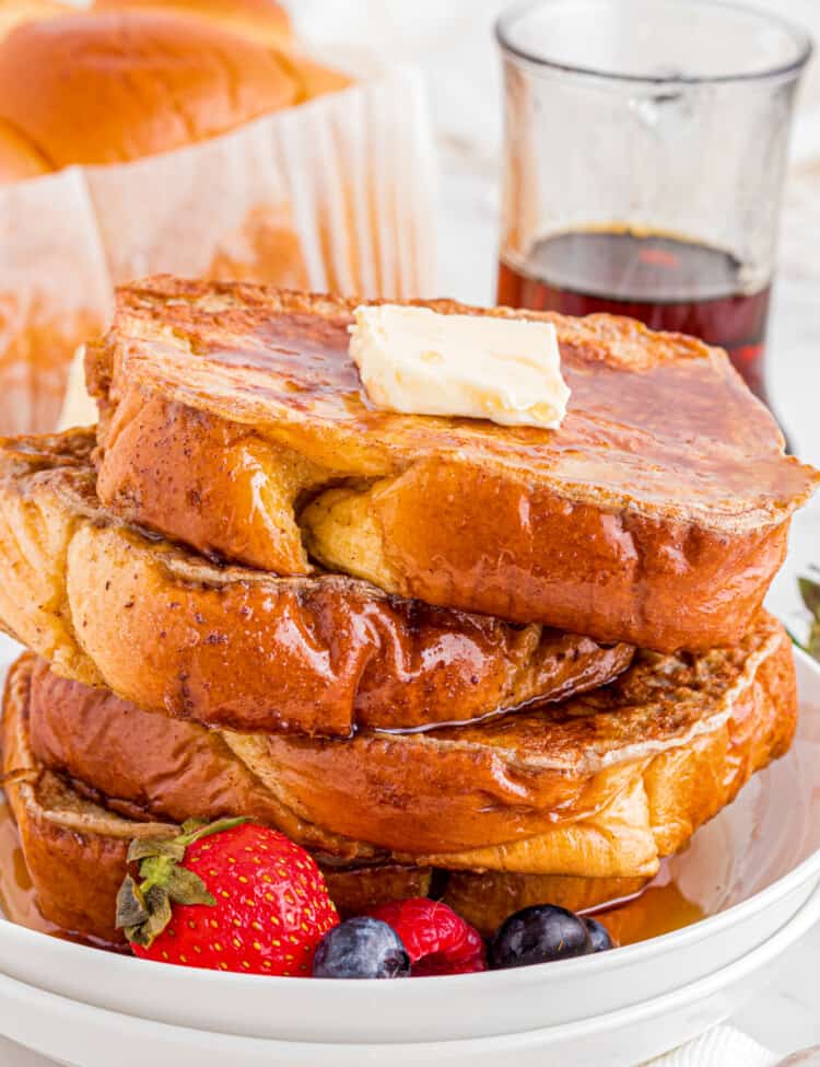 Stack of Brioche French Toast on white plate