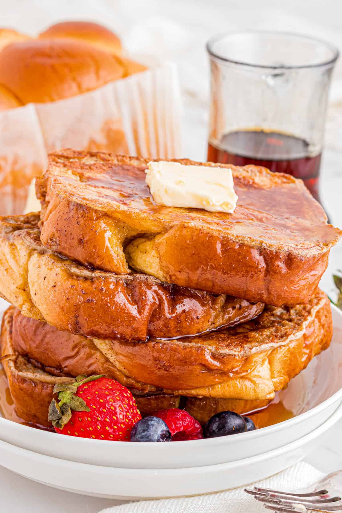Stack of Brioche French Toast on white plate