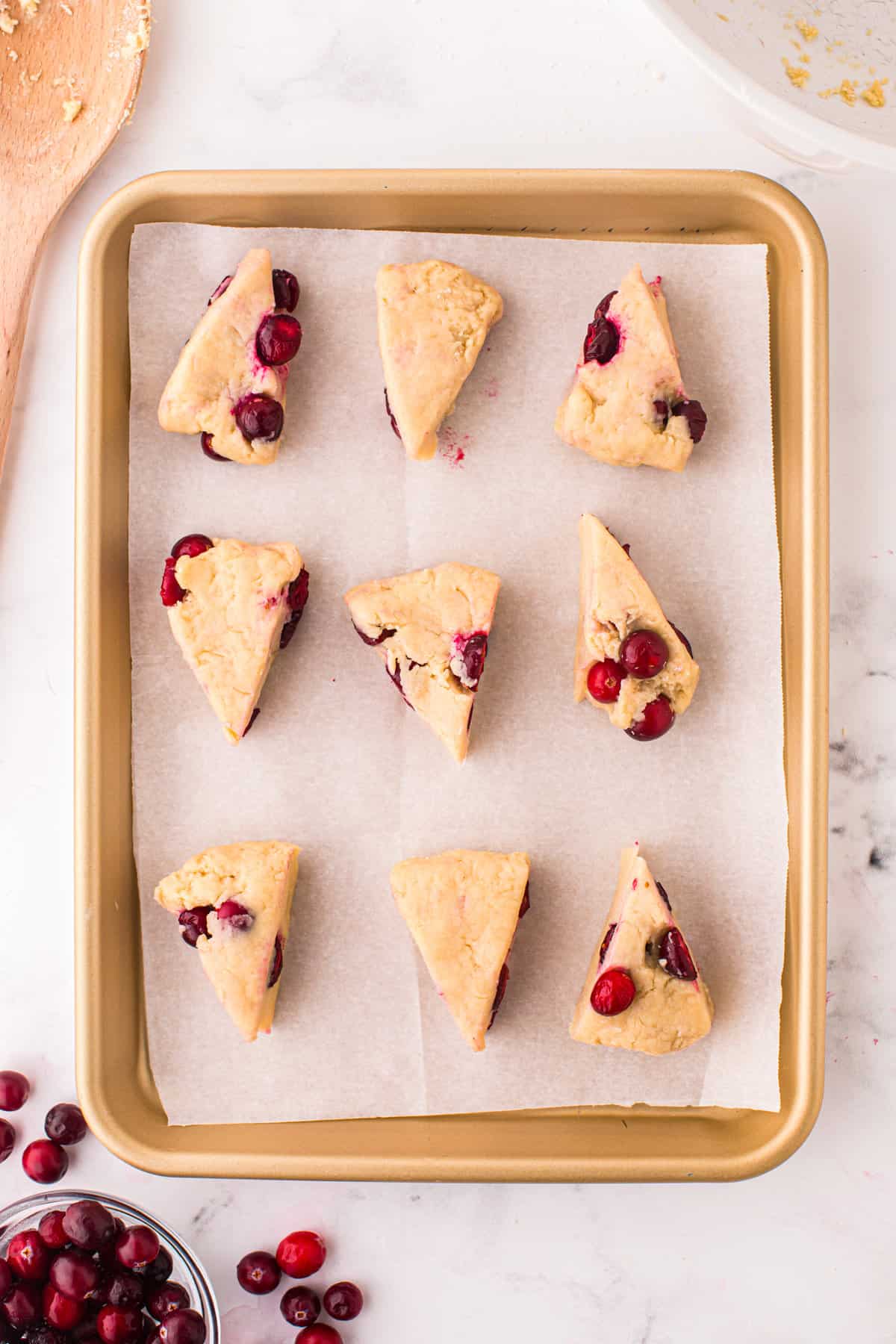 Cranberry Scones dough cut into wedges on baking sheet