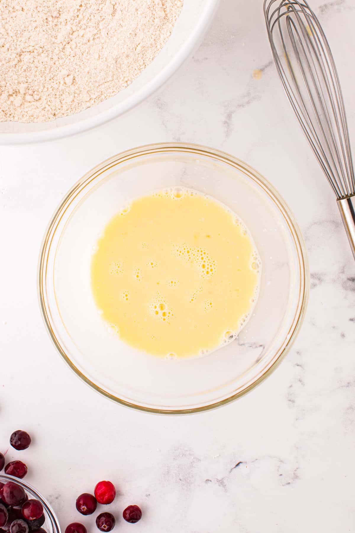 Egg and milk in bowl whisked together