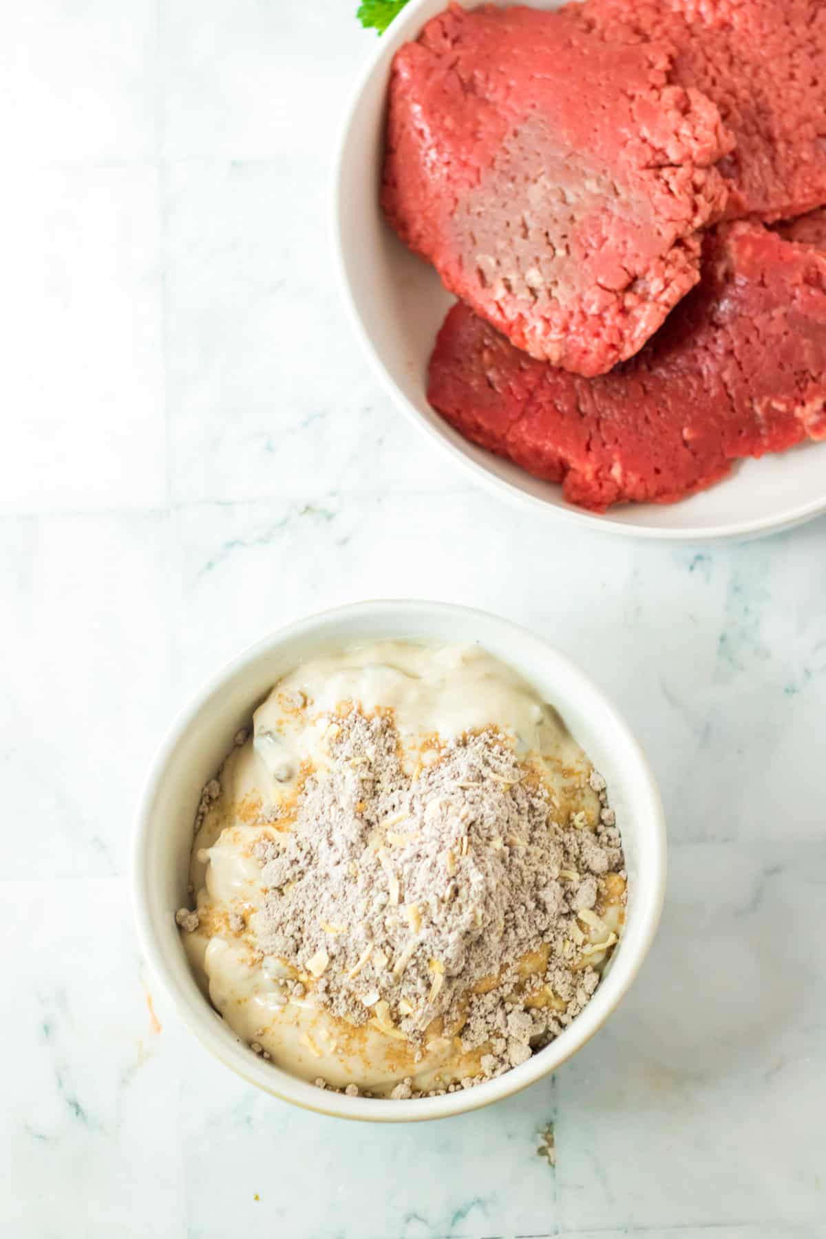 White bowl with cream of mushroom soup and dry onion soup mix