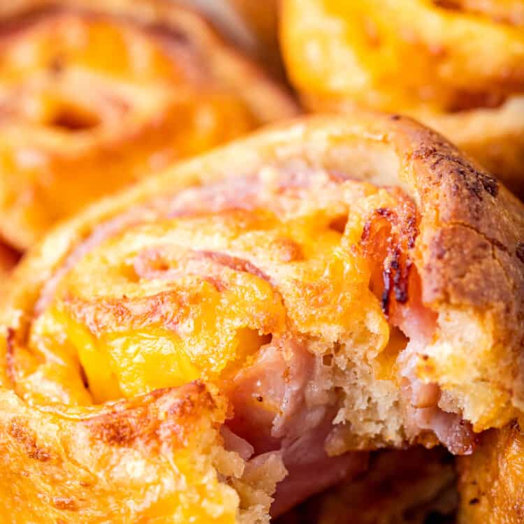 Baked ham and cheese pinwheels with bite out of it