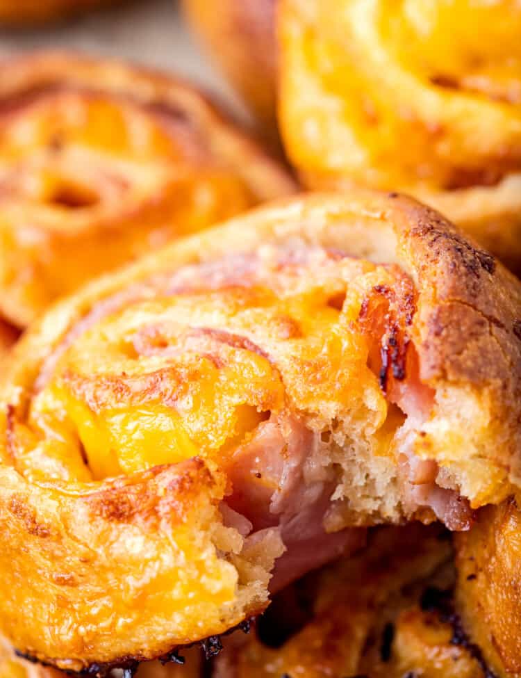 Baked ham and cheese pinwheels with bite out of it