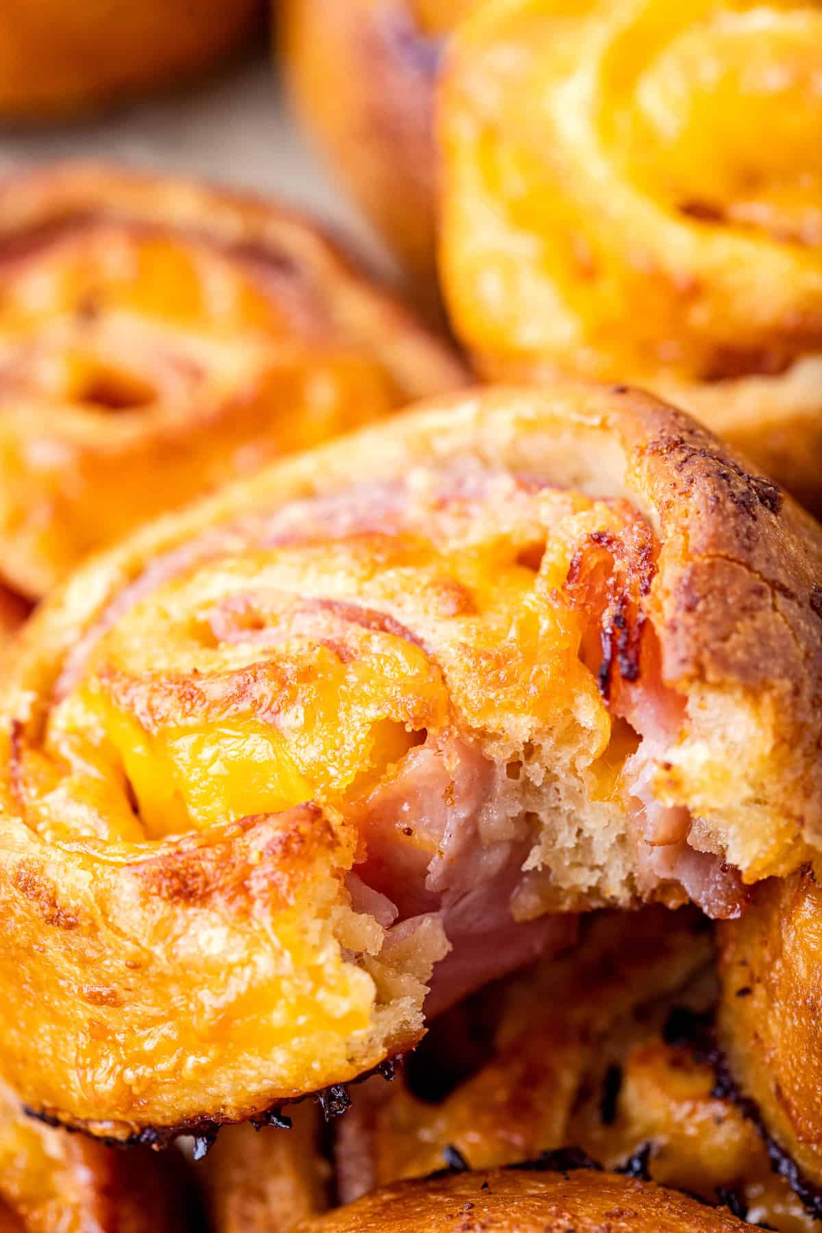 Baked ham and cheese pinwheels with bite out of it