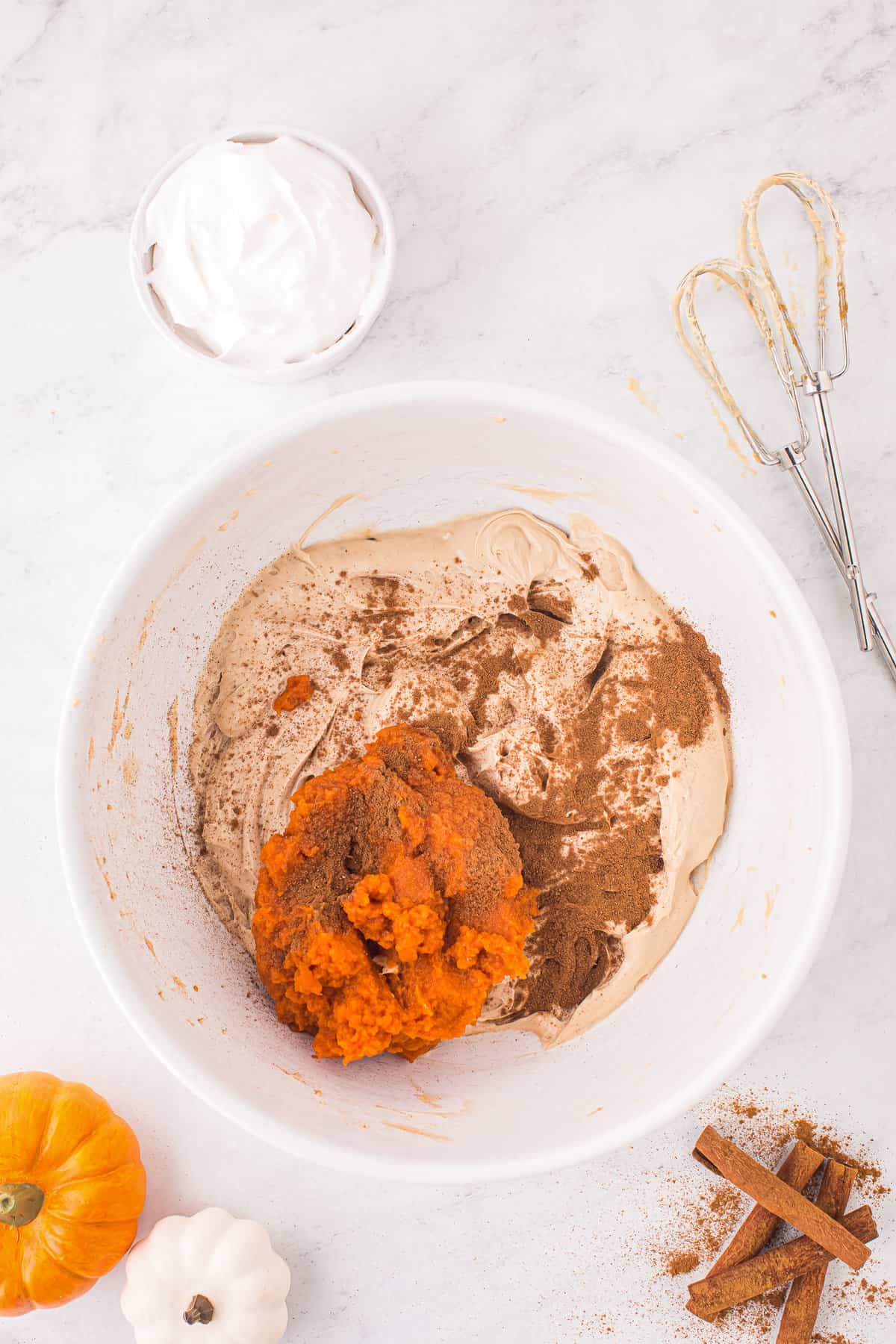 Pumpkin puree and cream cheese and spices in bowl
