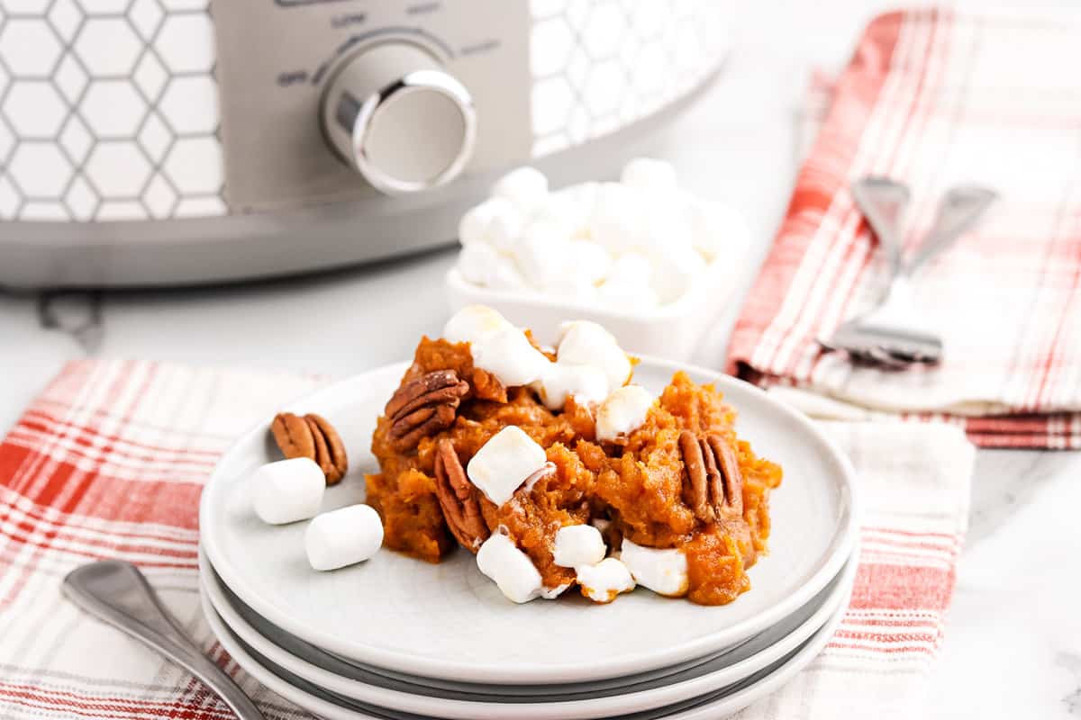 Sweet potato casserole with marshmallows on white plate