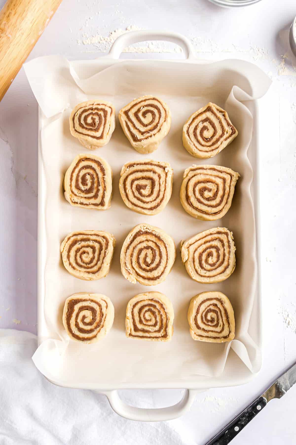Raw cinnamon rolls in pan