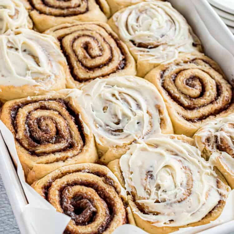 Pan of cinnamon rolls with some frosting