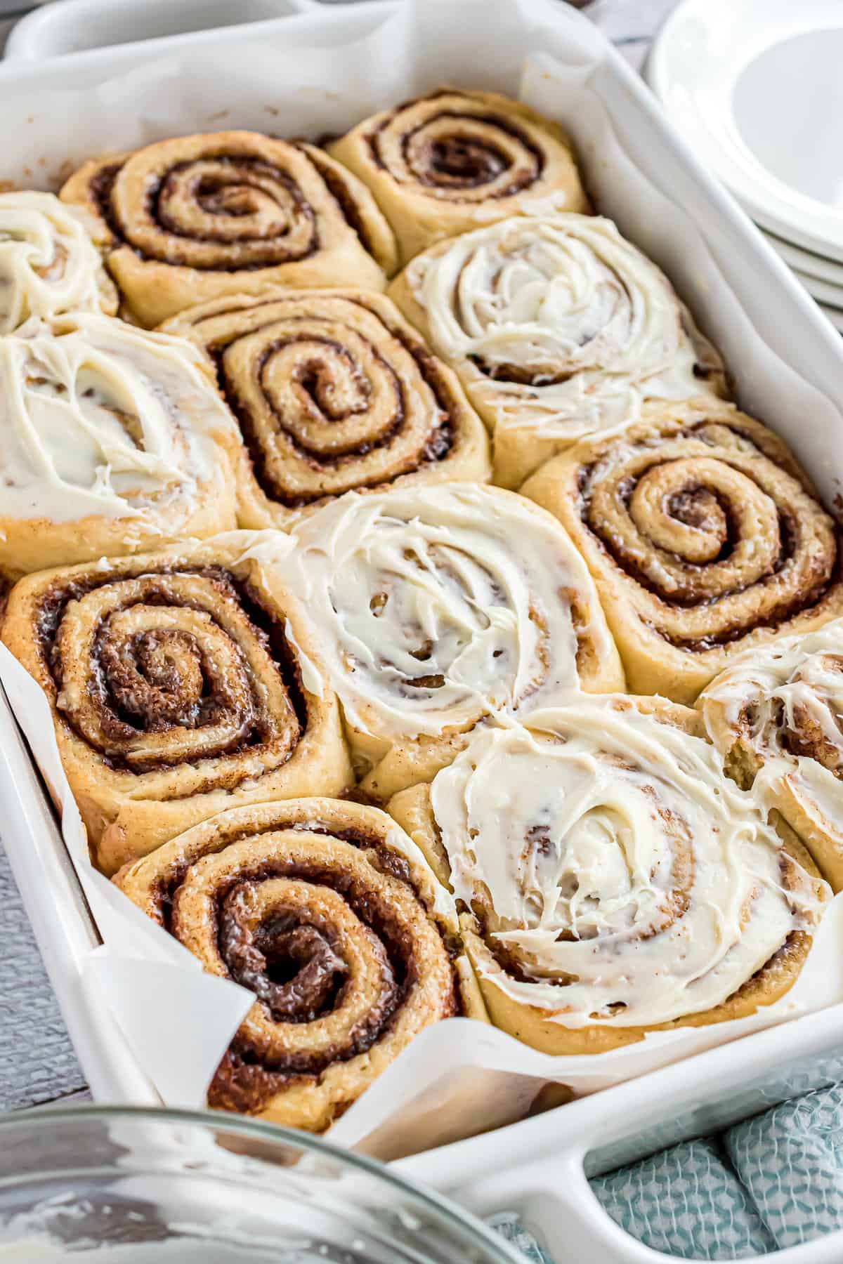 Pan of cinnamon rolls with some frosting