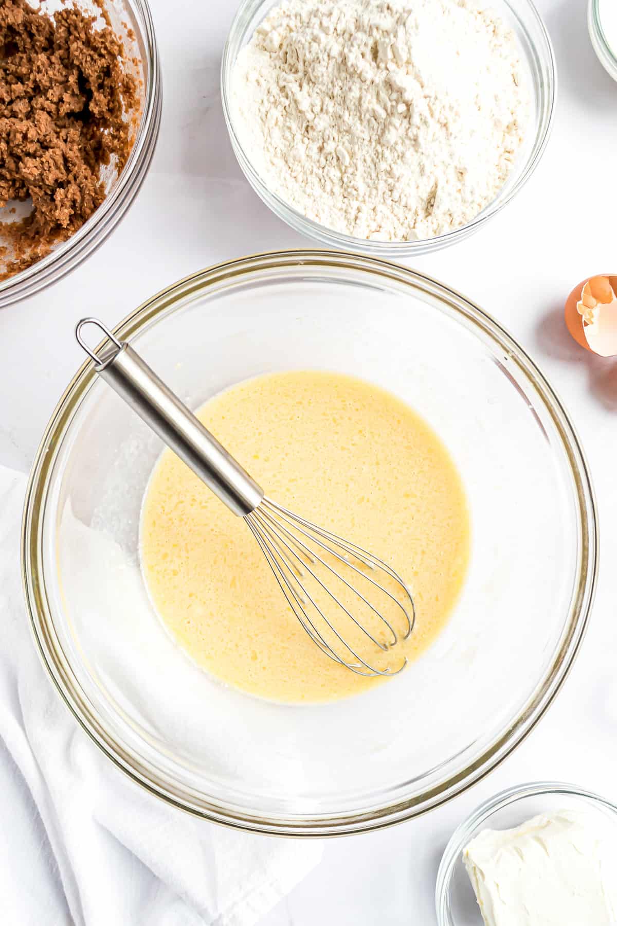 Bowl with mixed wet ingredients for cinnamon rolls