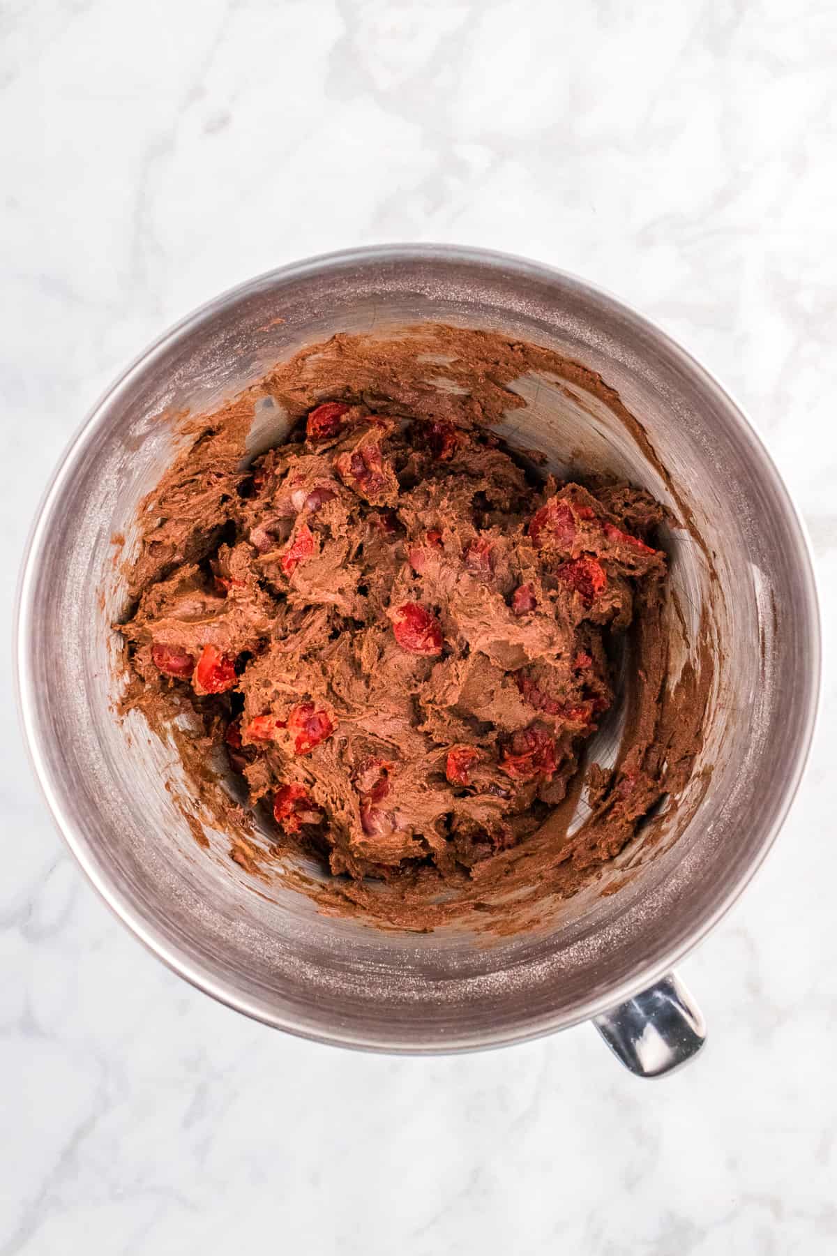 Overhead image of mixing bowl with chocolate cherry cookie dough