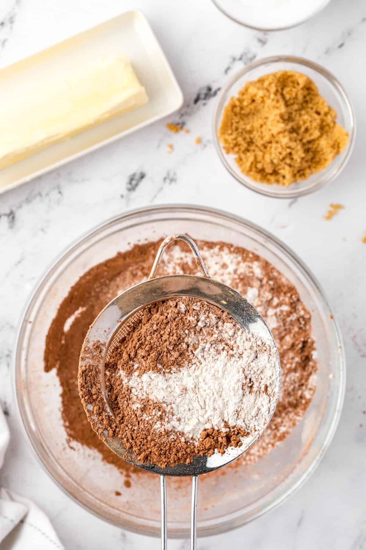 Sifting dry ingredients into bowl