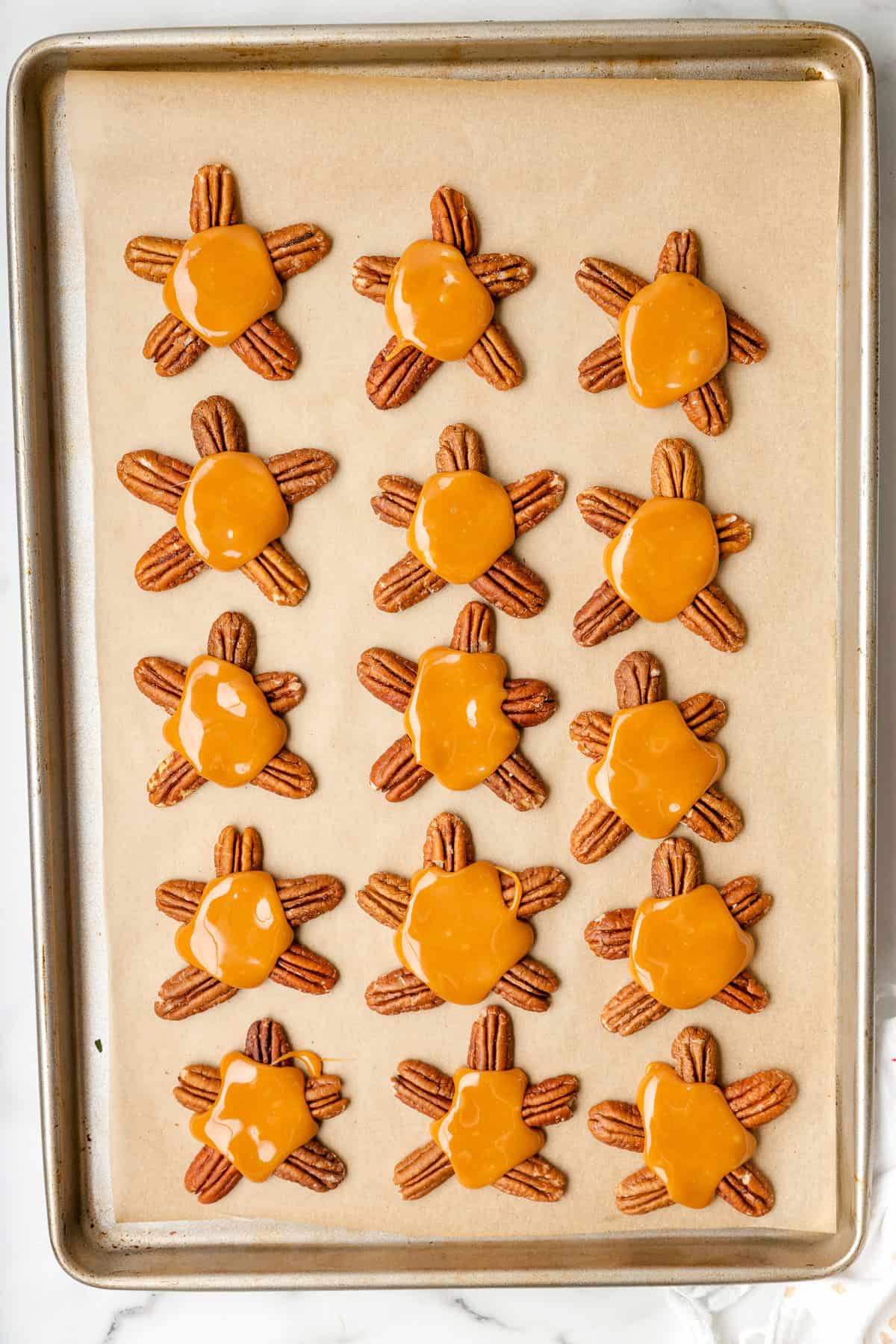 Pecan halves arranged in a star topped with caramel