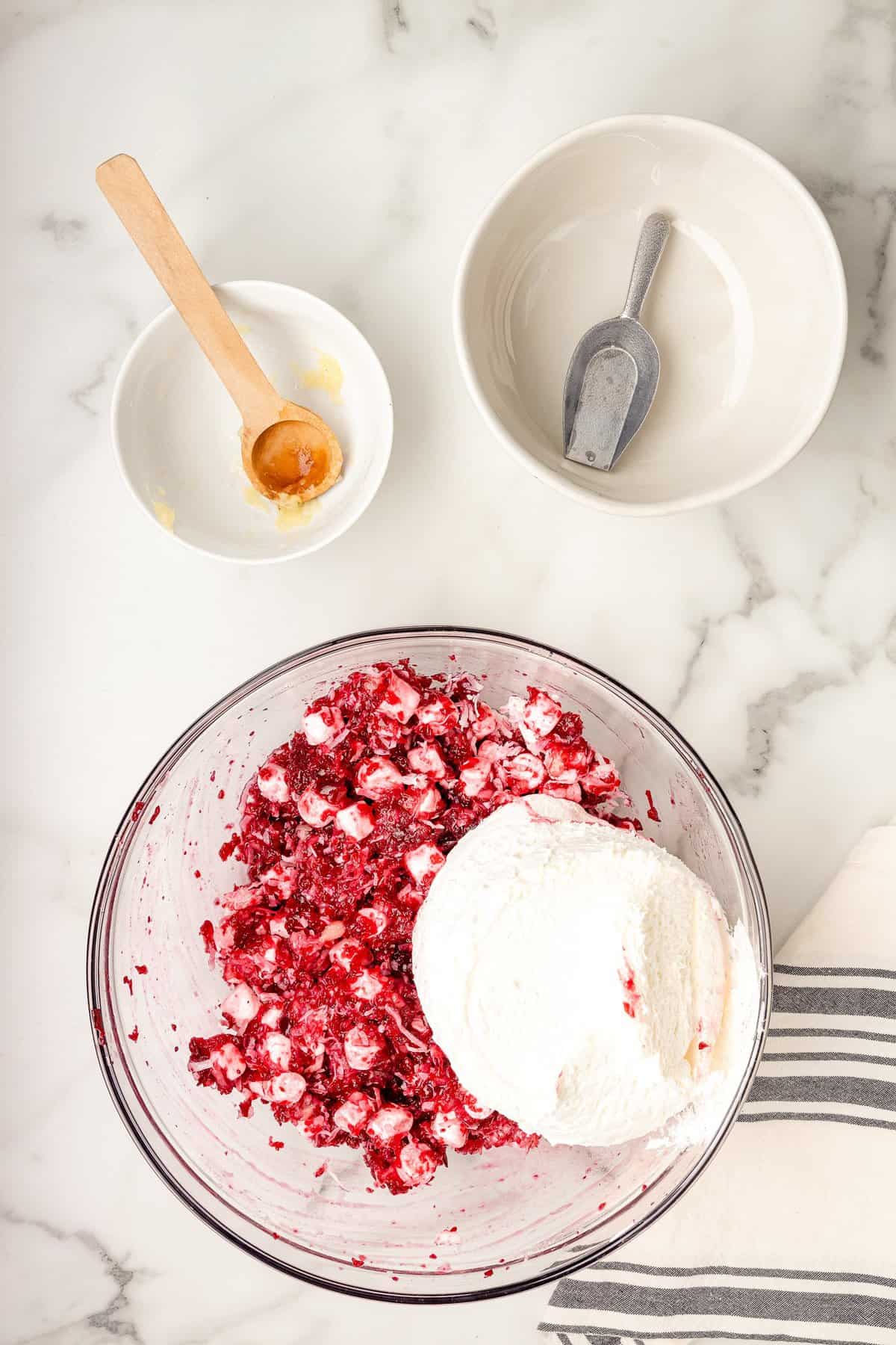 Cool whip in bowl with cranberries for salad