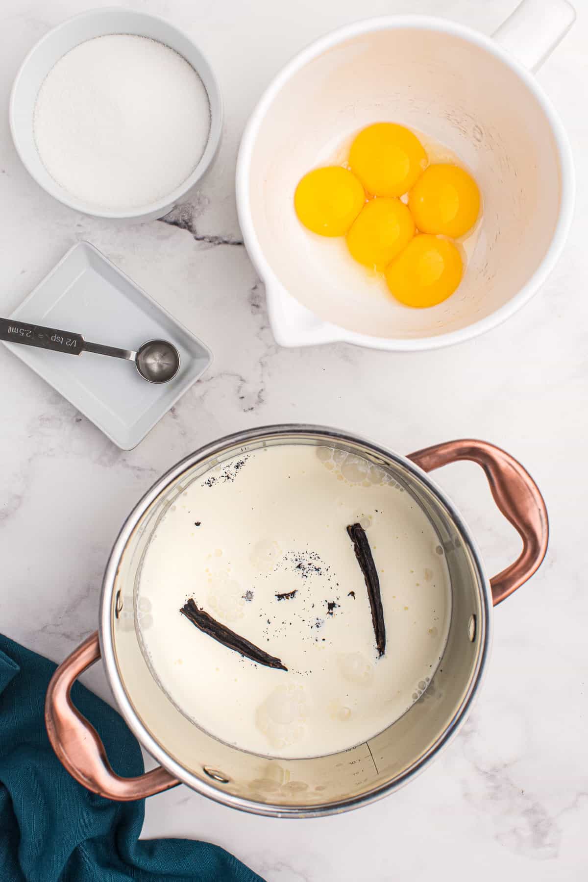 Saucepan with cream and vanilla bean