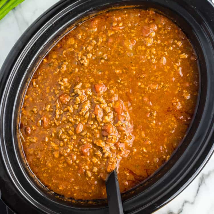 Ladle lifting chili out of crock pot
