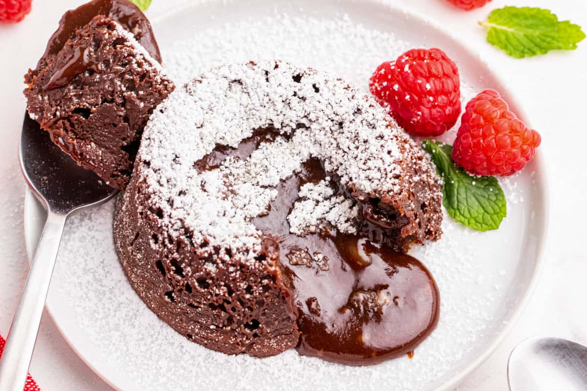 Molten Lava Cake topped with powdered sugar and molten chocolate coming out of center