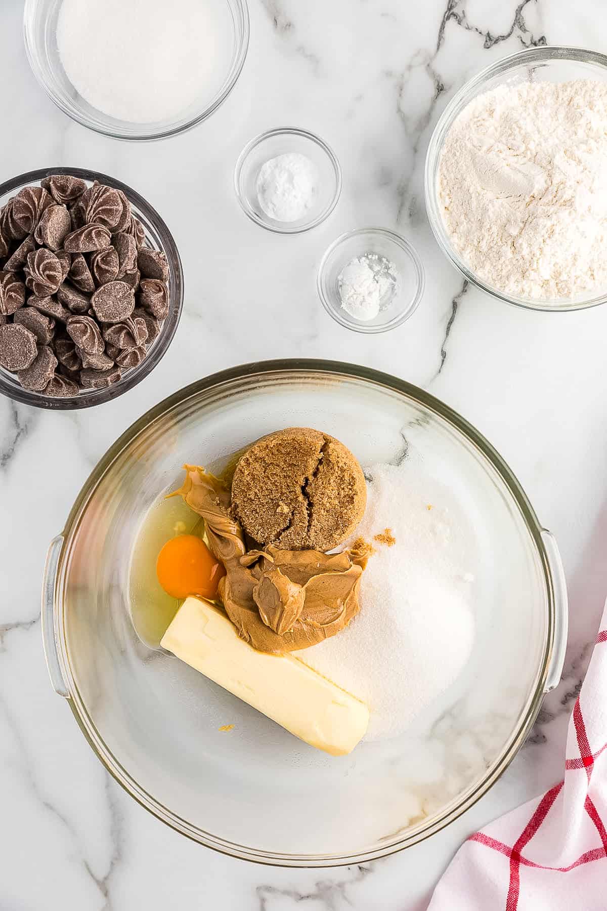 Glass bowl with cookie dough ingredients before creaming together