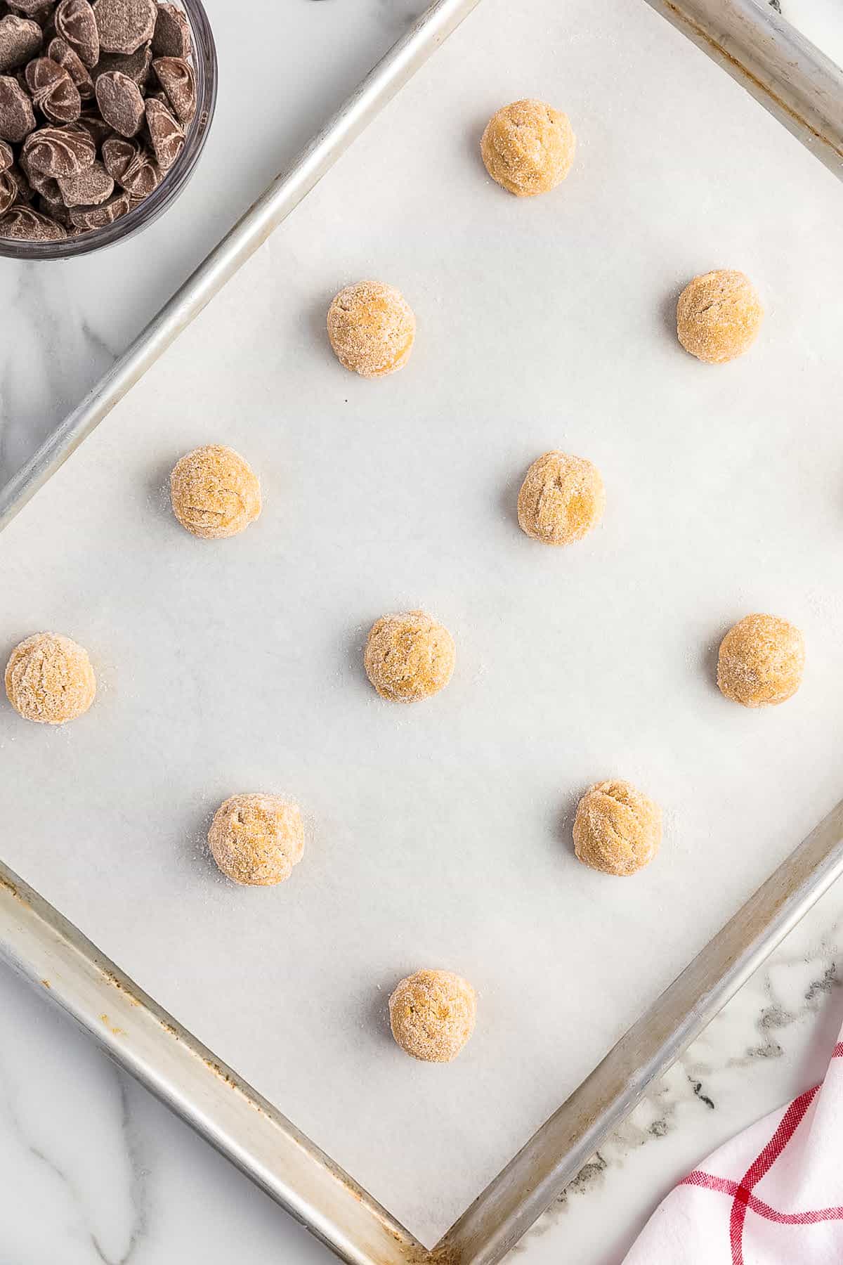 Overhead image of balls of peanut butter cookie dough rolled in sugar