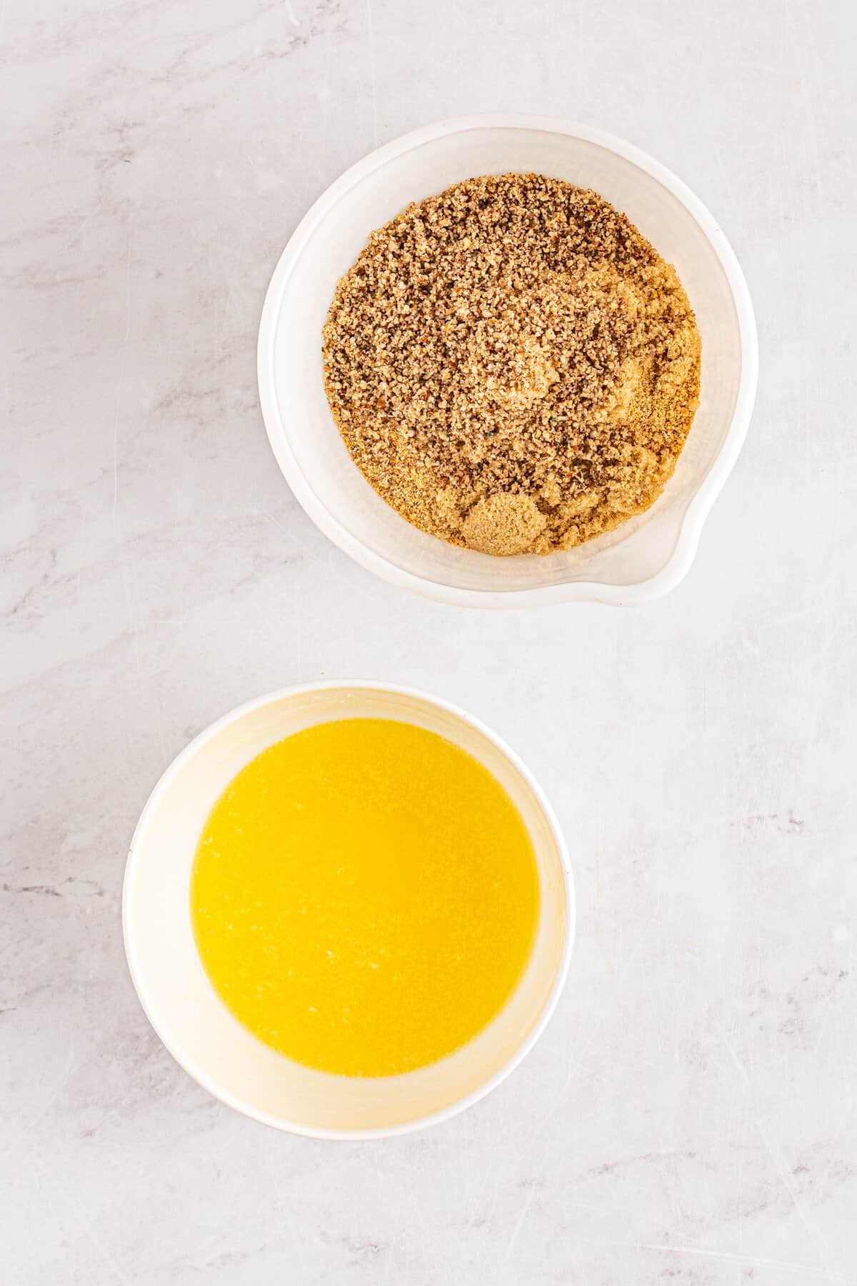 Bowls of melted butter and graham cracker crumbs