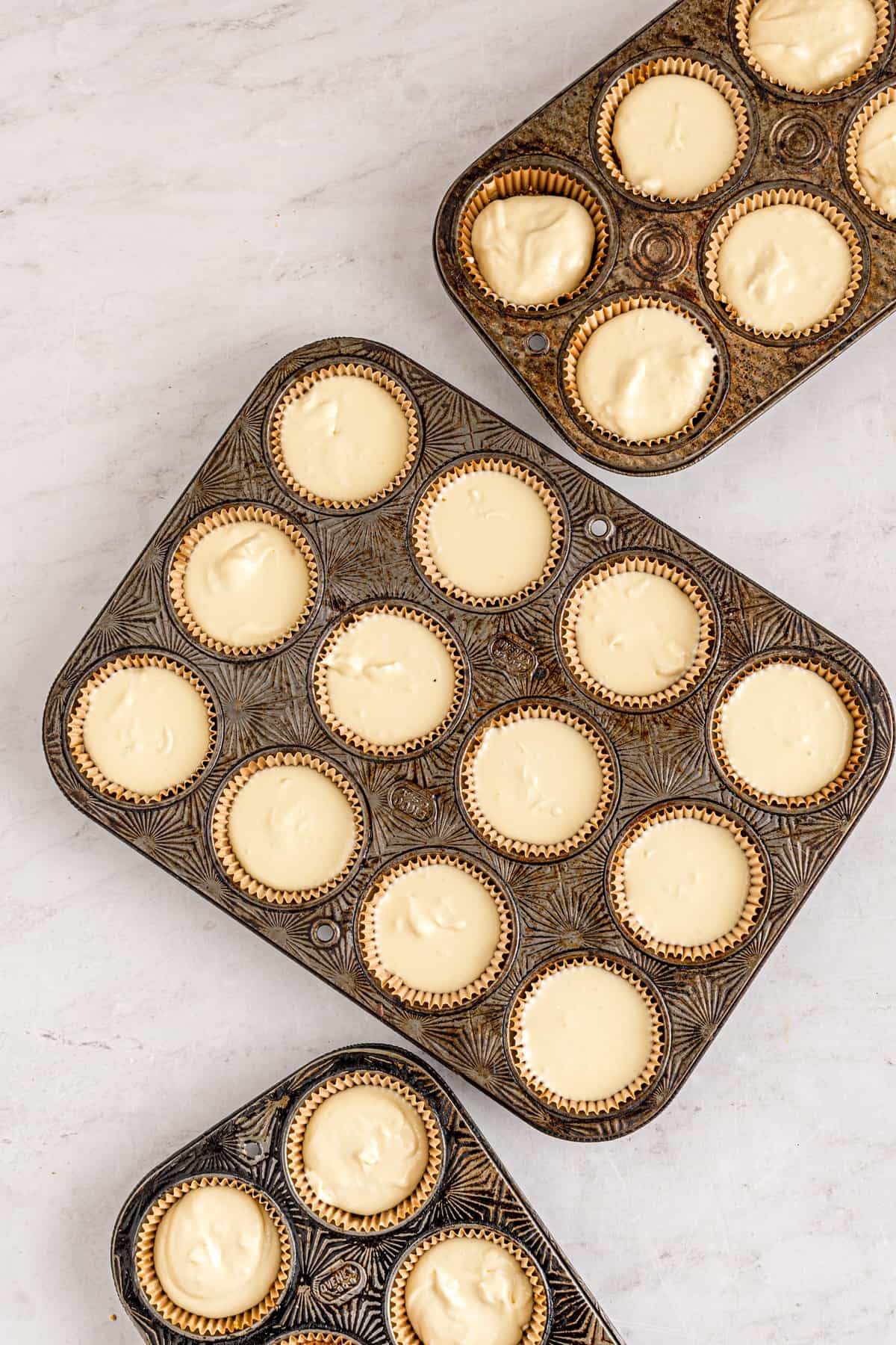 Mini cheesecakes before baking in mini muffin pan