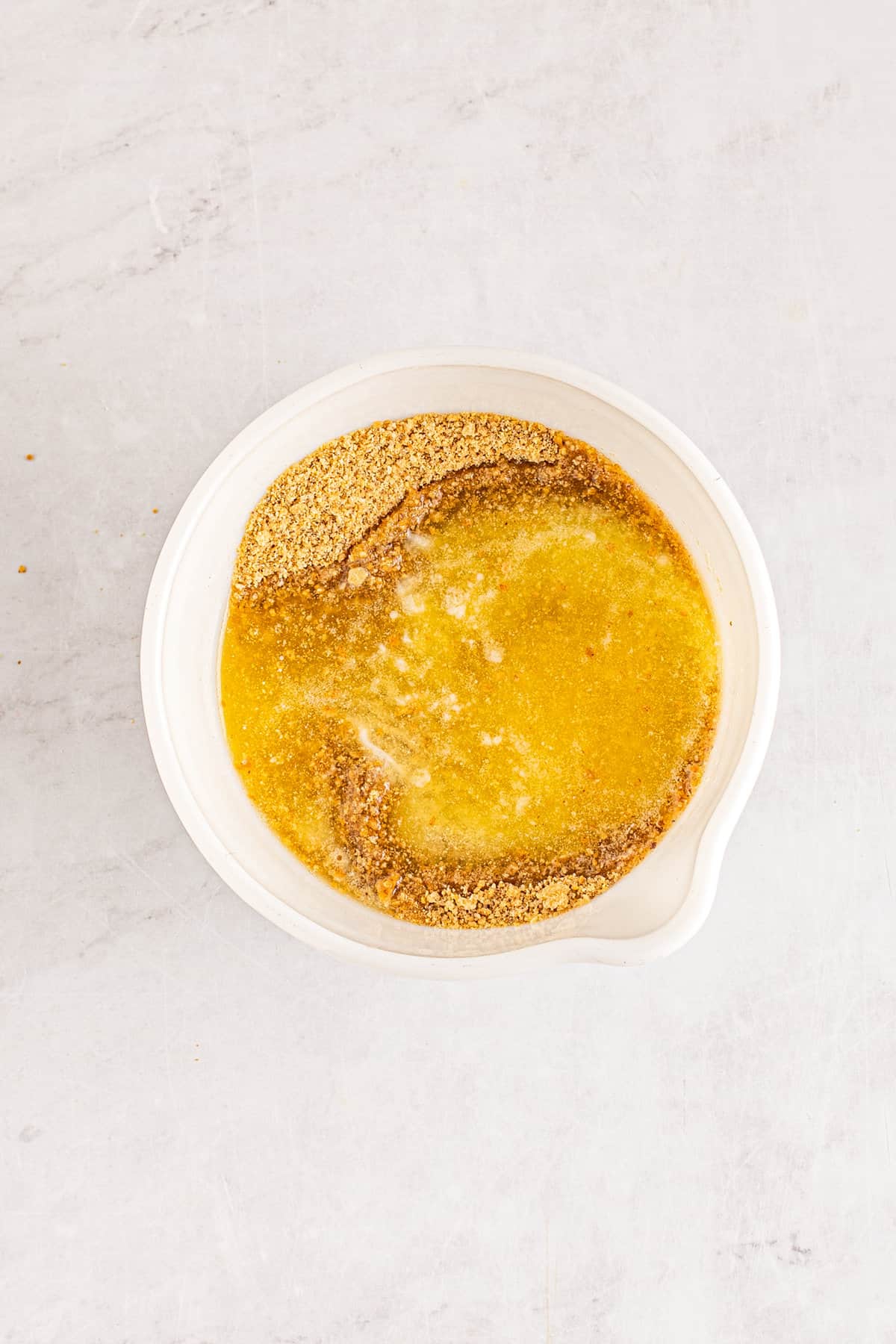 Bowl with melted butter and graham cracker crumbs