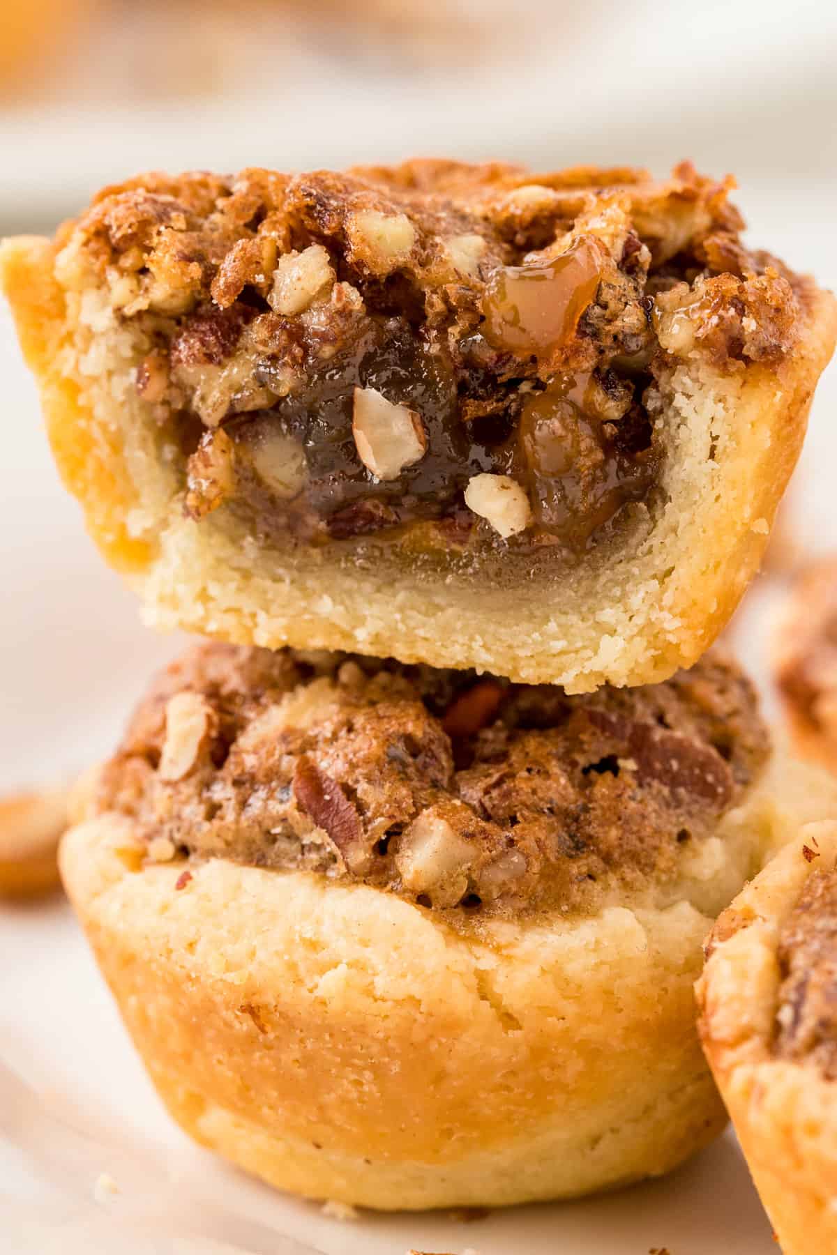 Stack of two pecan tassies with top cut in half