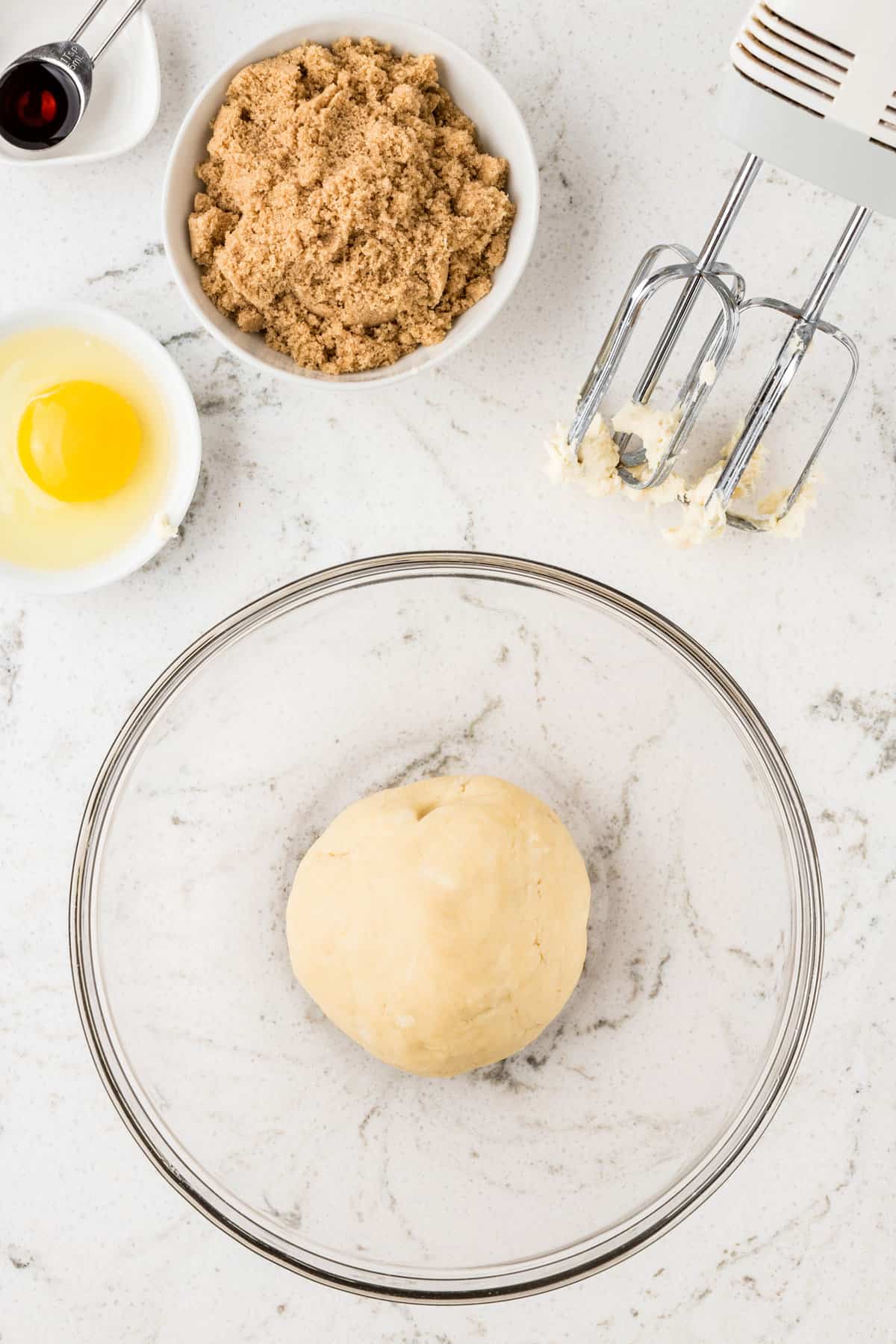 Round dough ball in glass bowl