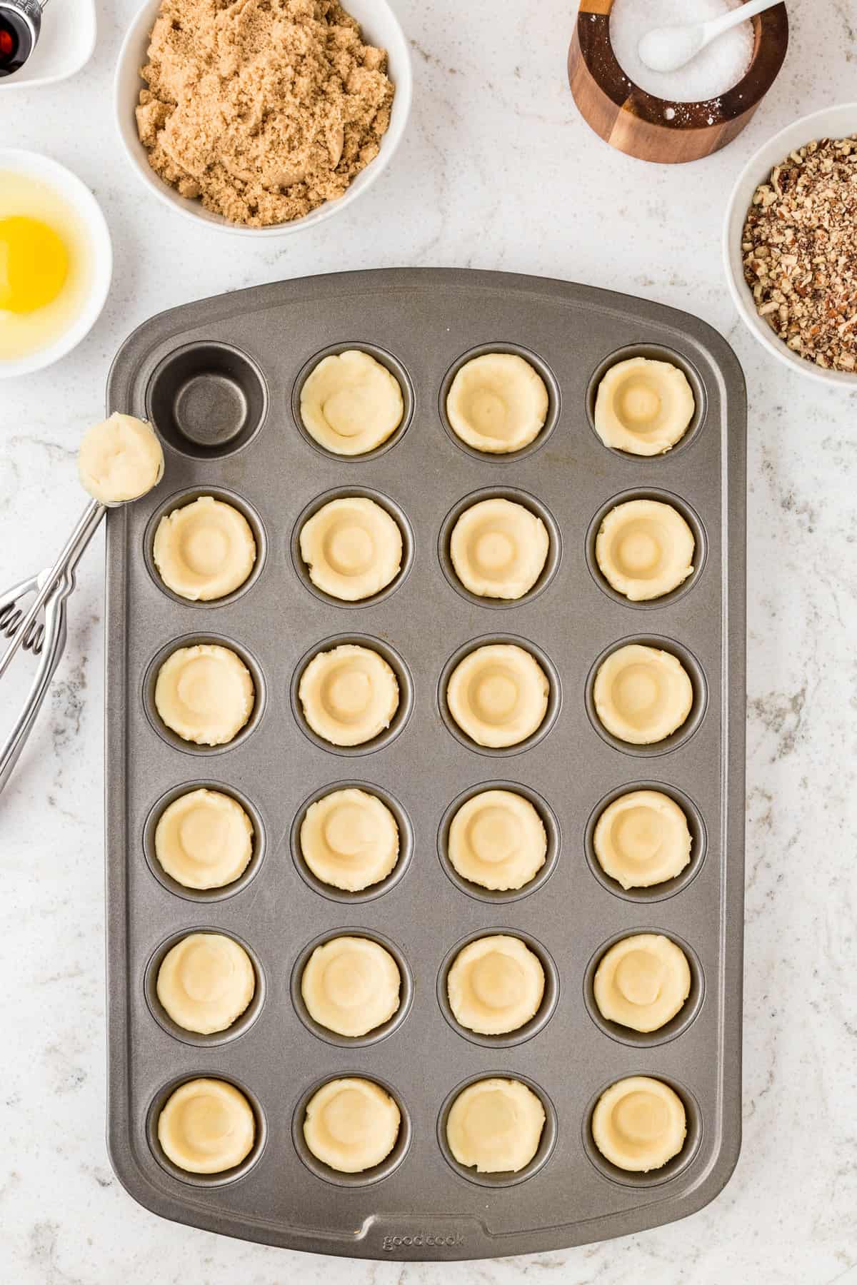 Mini muffin pan with dough pressed into them