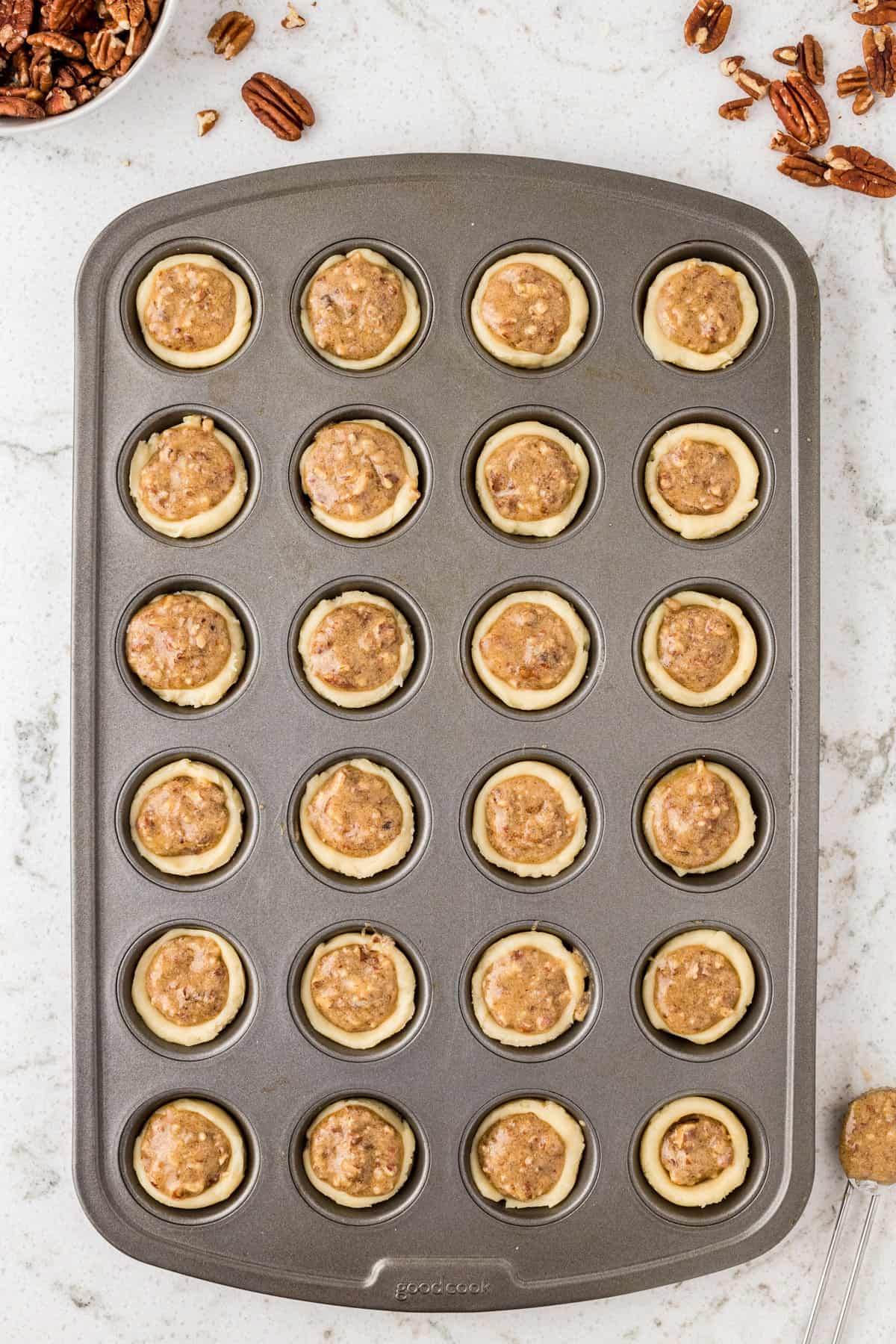 Unbaked pecan tassies in mini muffin tin