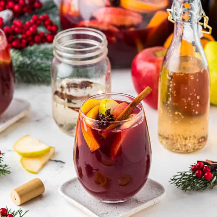 Red Christmas Sangria in glass with fruit