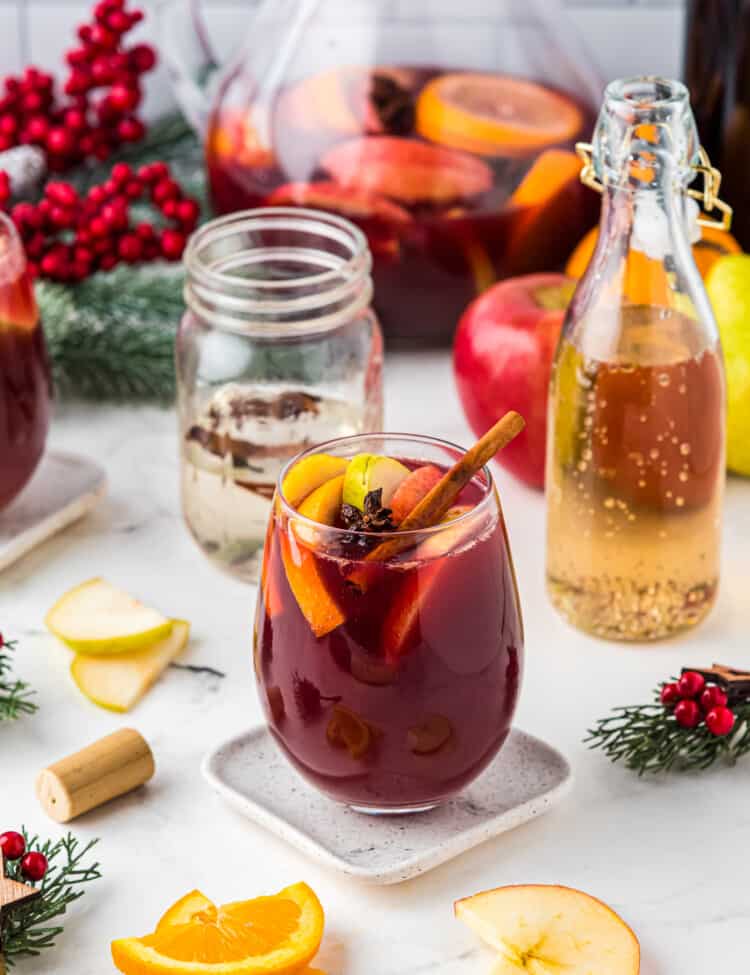 Red Christmas Sangria in glass with fruit