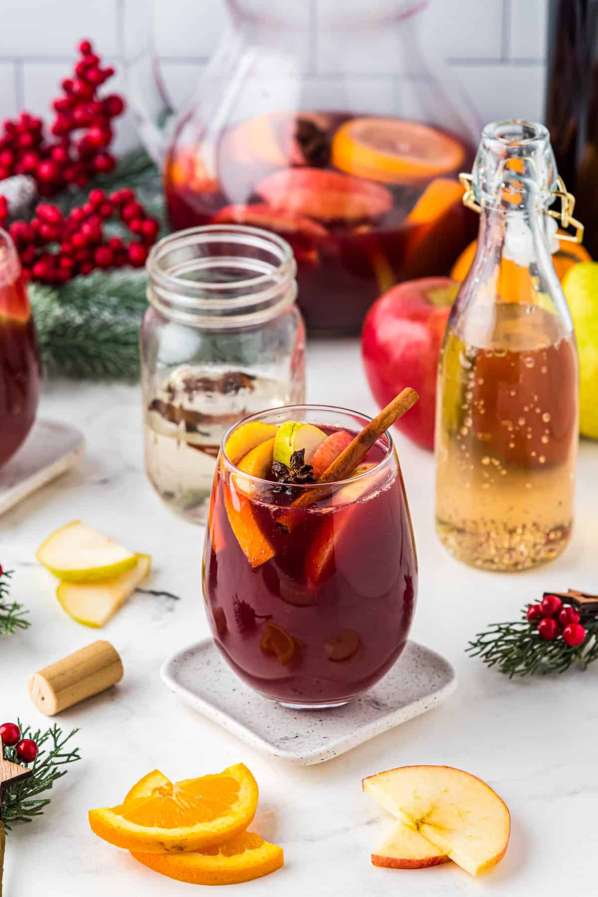 Red Christmas Sangria in glass with fruit