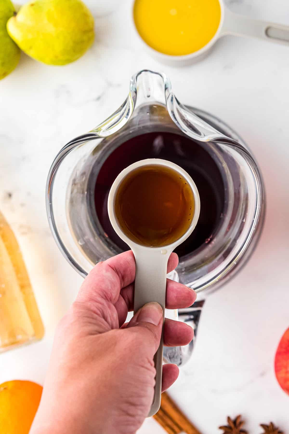 Overhead image of pouring brandy into sangria