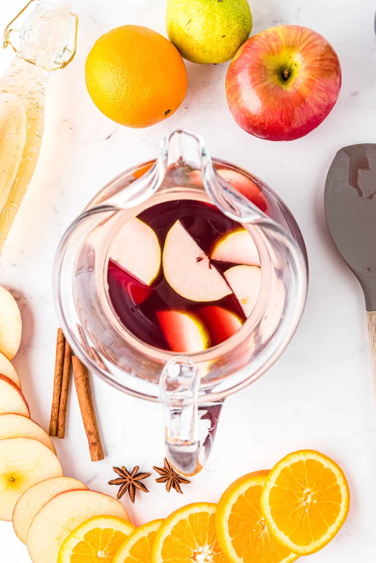 Red Sangria in pitcher with sliced apples