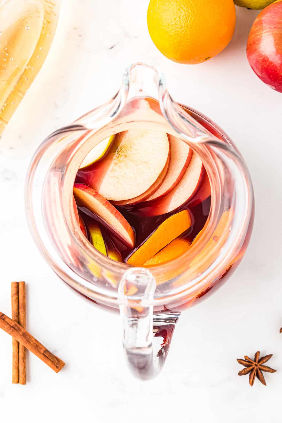 Overhead image of pitcher with red sangria and fruit