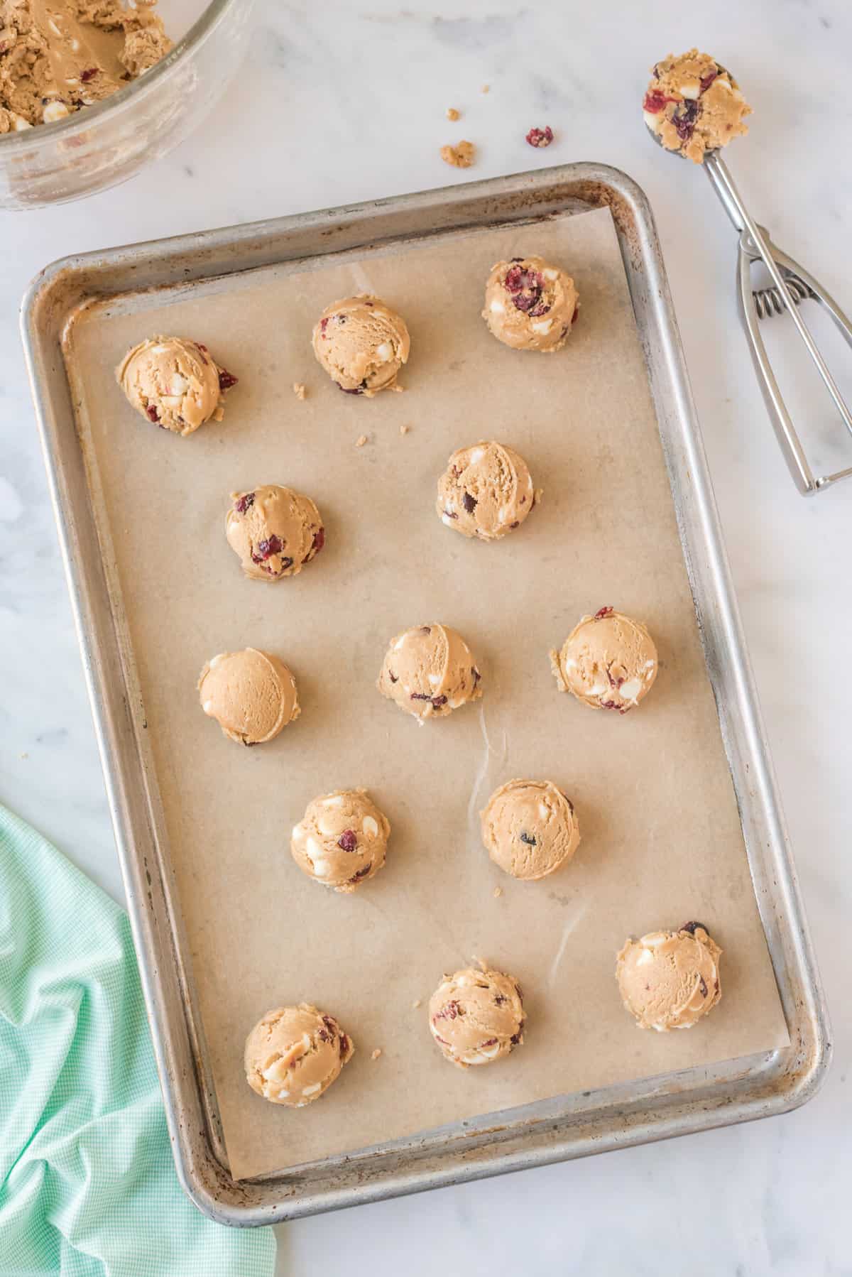 cranberry white chocolate chip cookie dough balls on baking sheet