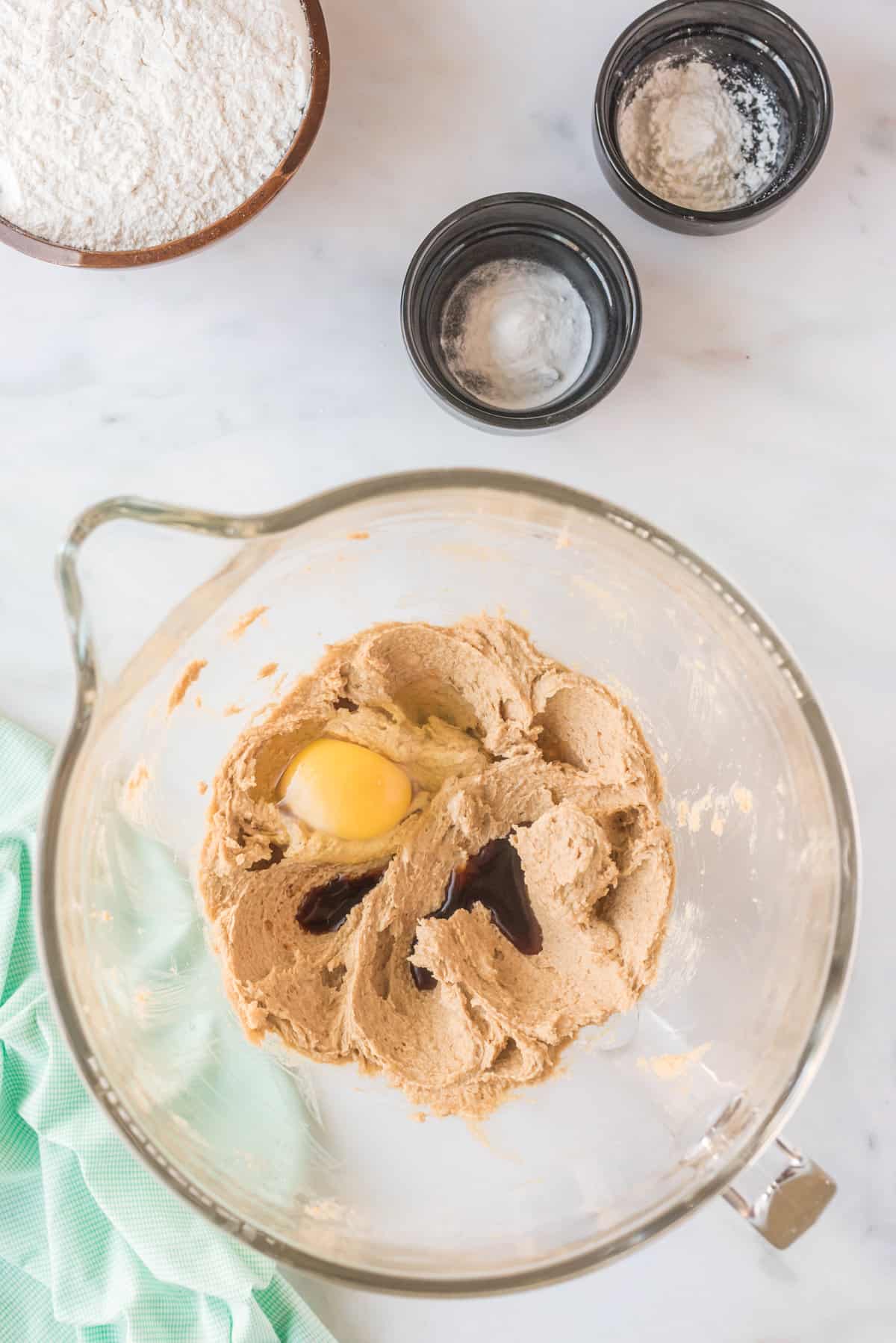 Mixing bowl with butter and sugars creamed plus egg