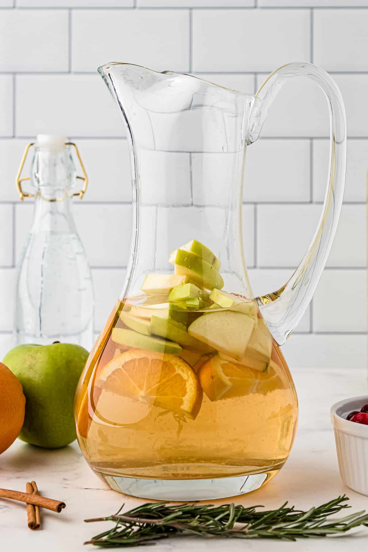 Pitcher with oranges, apples and white sangria