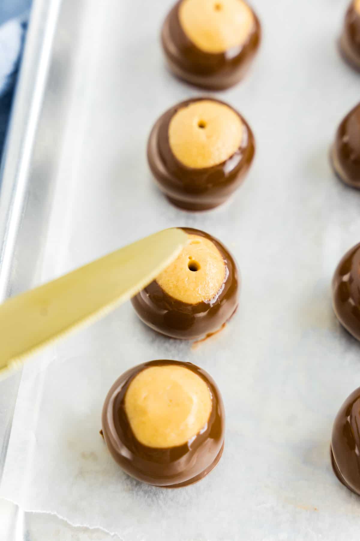 Knife smoothing out holes in buckeyes