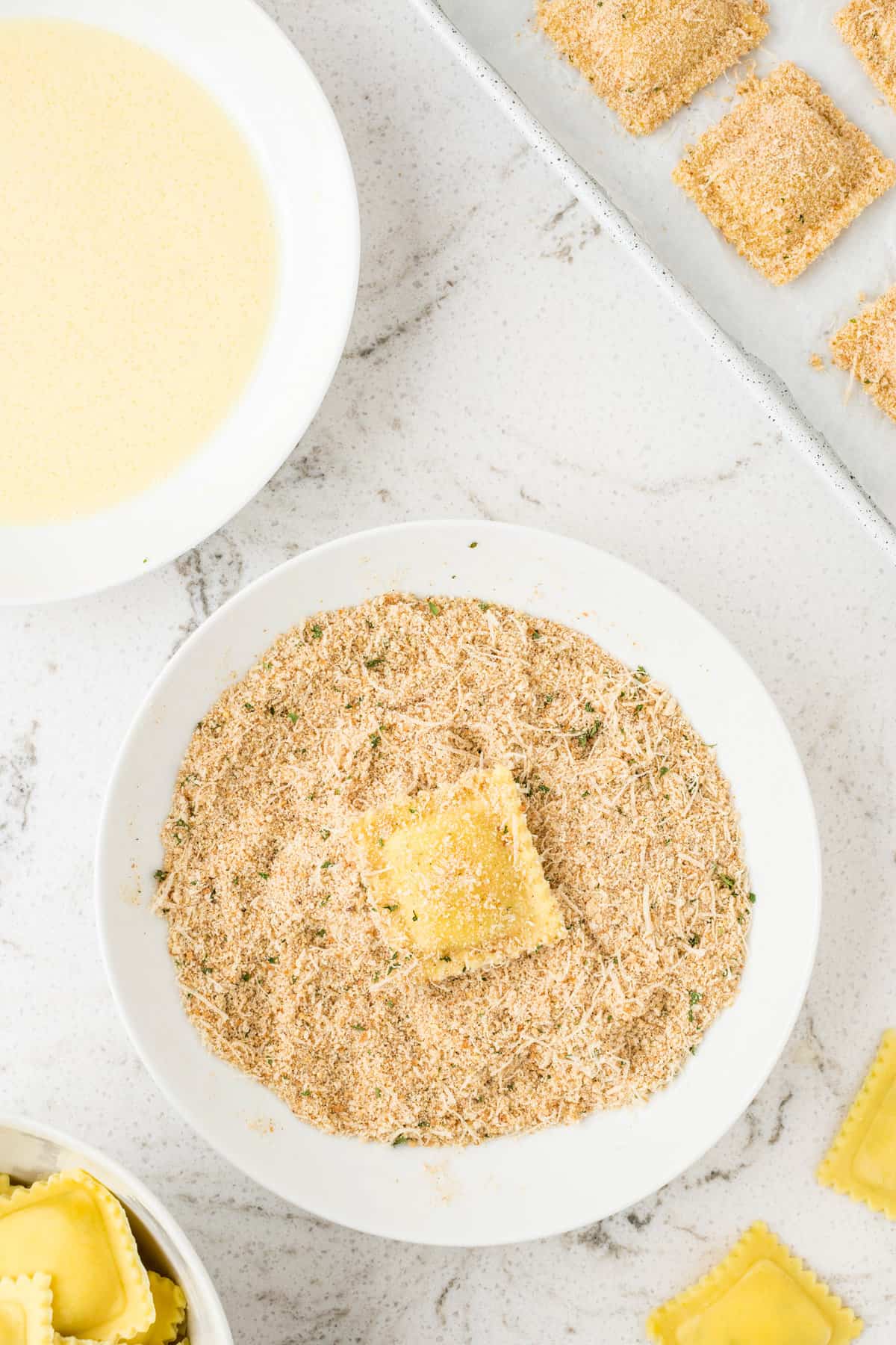 Overhead image of ravioli in Italian breadcrumbs and parsley