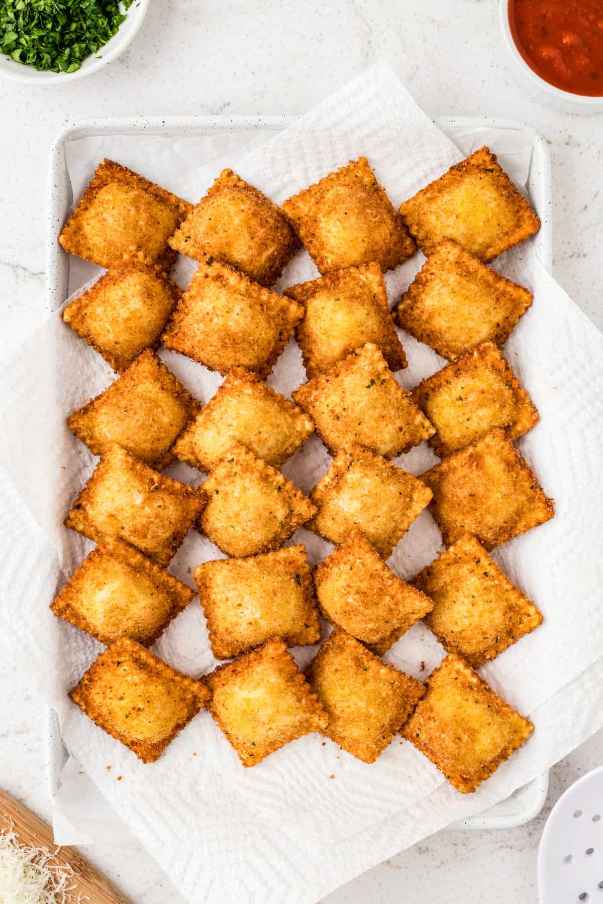 Fried ravioli on paper towel lined baking sheet