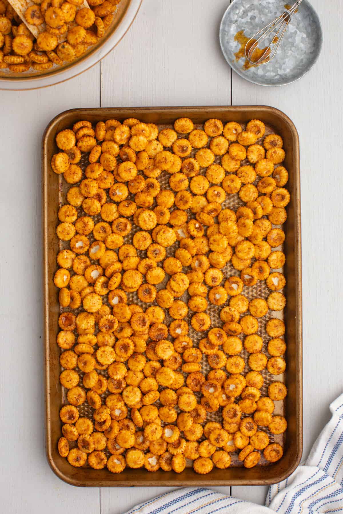 Taco Oyster Crackers Mixed and Spread out on Lined Baking Pan Ready for the Oven