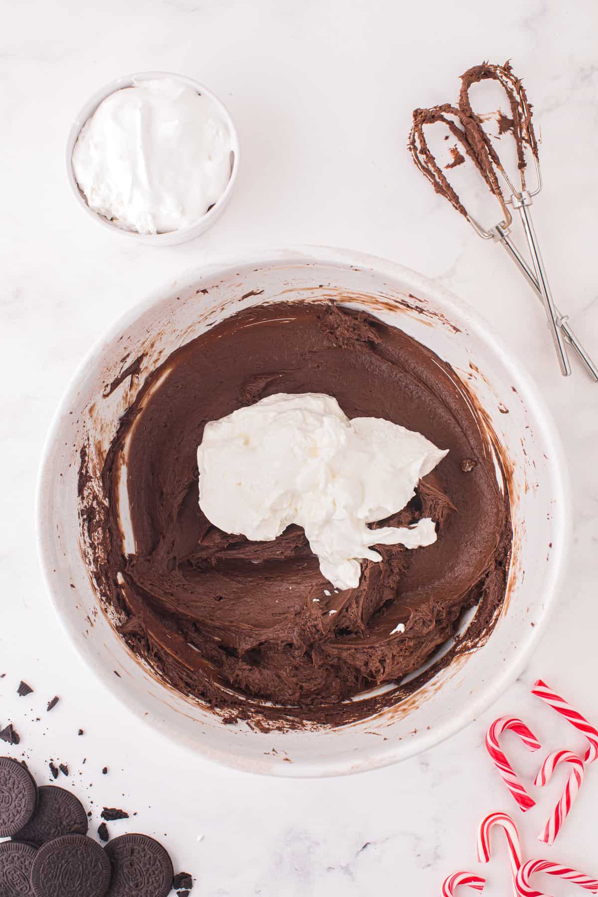 Whipping topping in bowl with chocolate cheesecake filling