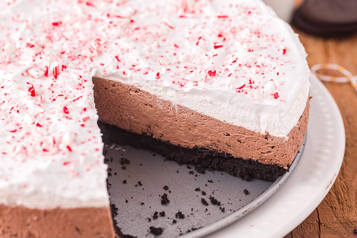 Peppermint cheesecake in pan with a slice gone