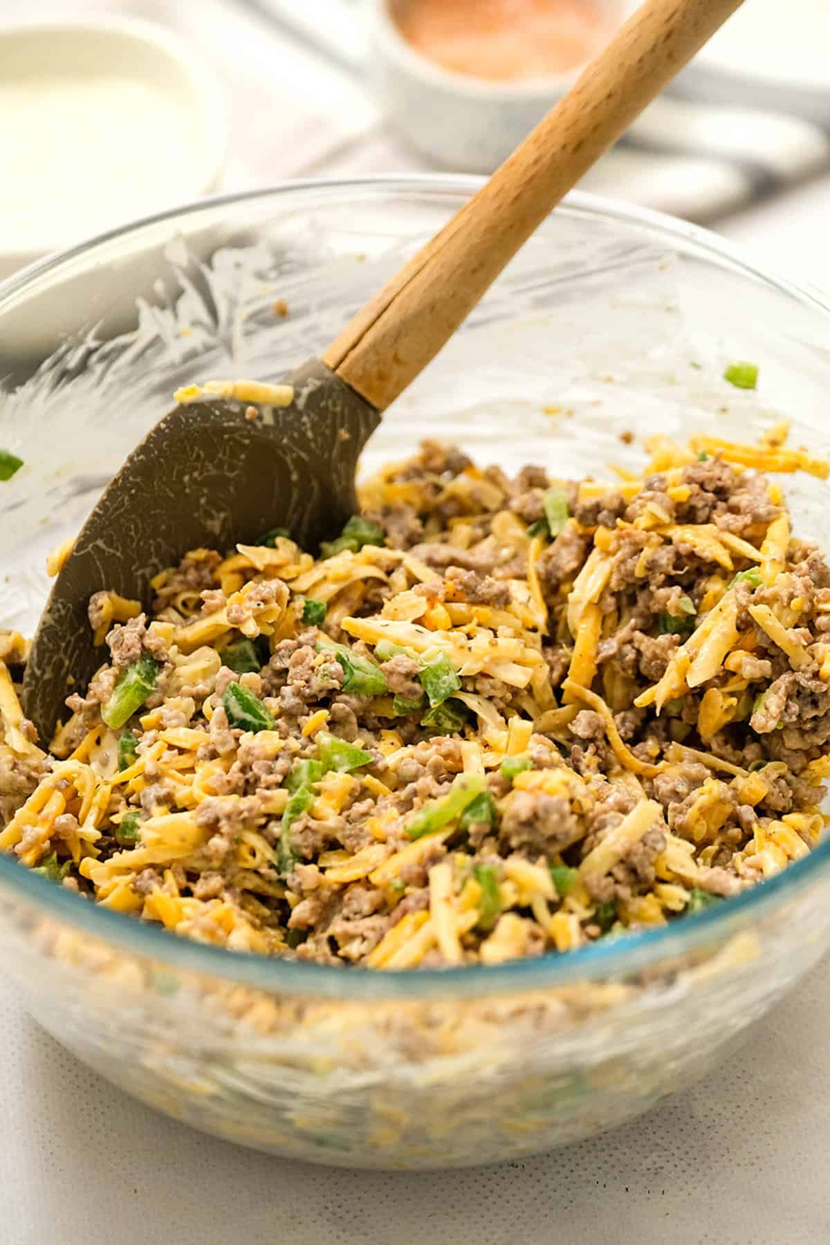 Savory Sausage Wonton Ingredients Mixed with Spoon in Glass Bowl